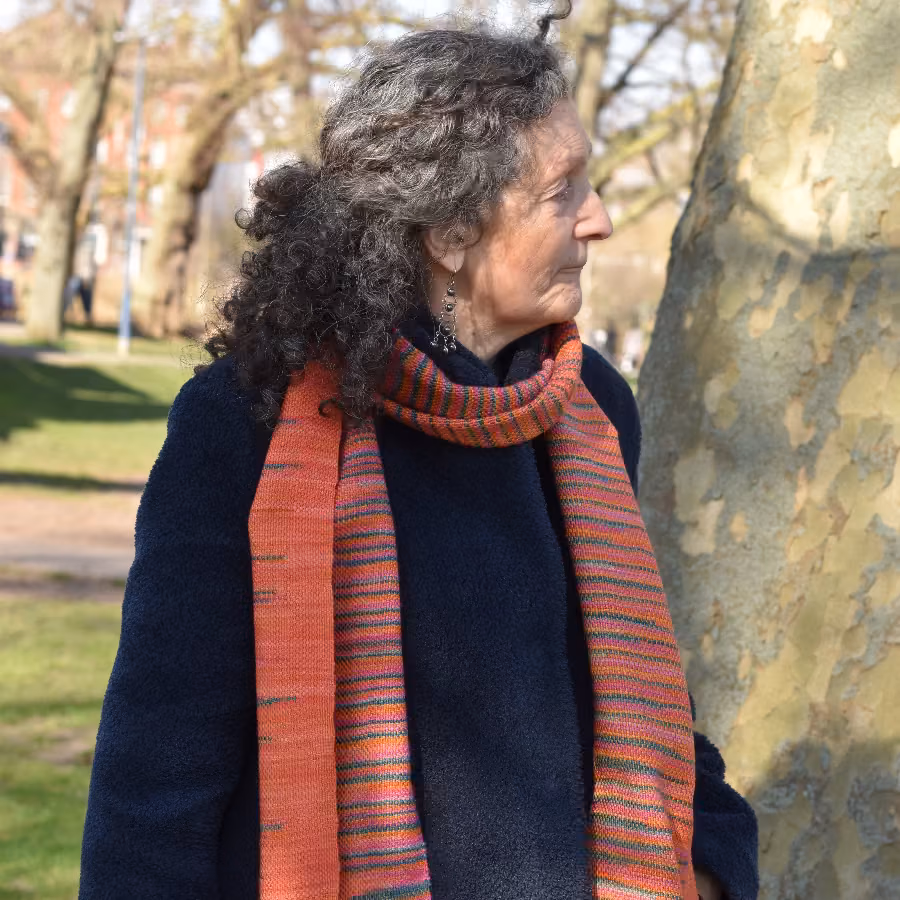 Anne-Marie looking left, modelling the Clasped Pattern Scarf
