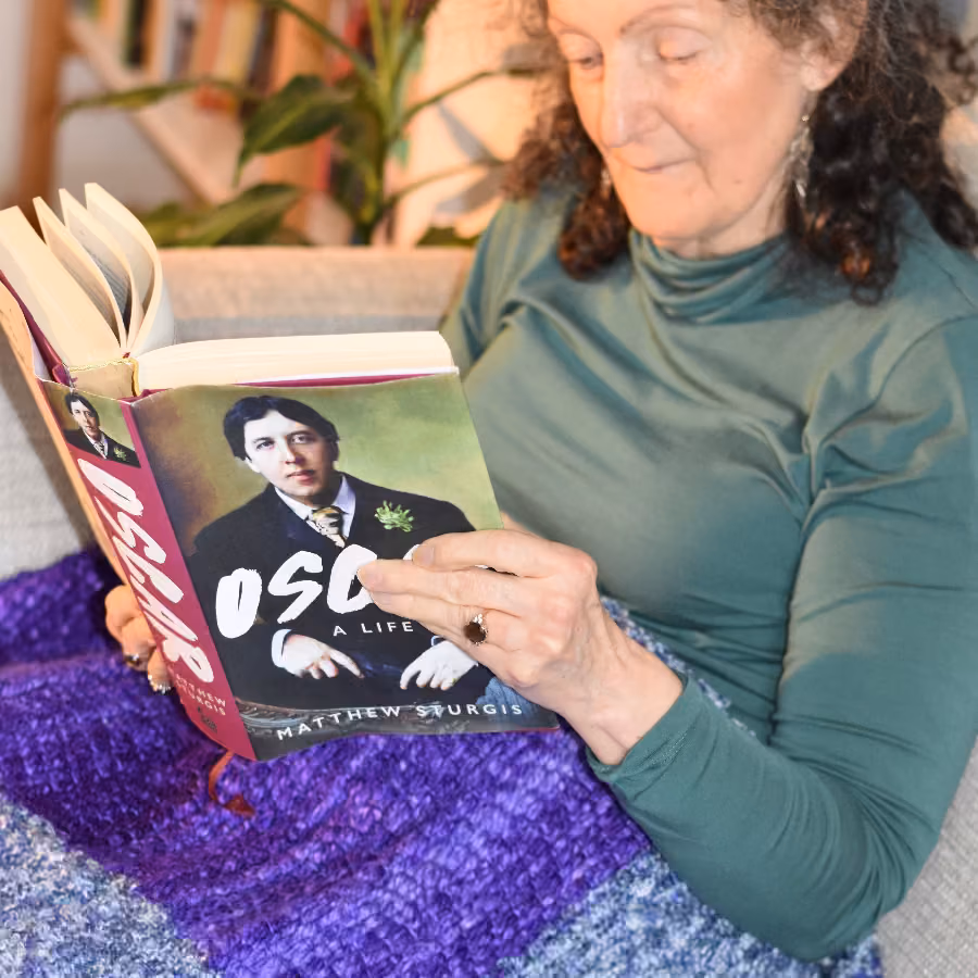 Anne-Marie reading a book with the Lap Wrap close up