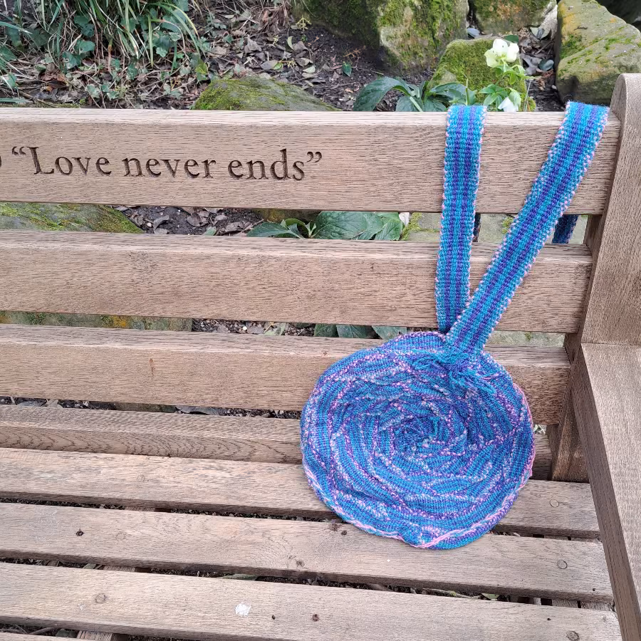 Round Inkle Bag hanging over bench