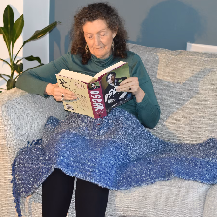 Anne-Marie reading a book with the Lap Wrap
