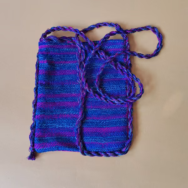 The pouch turned to its blue side, striped in blue and purple, with its cord coiled beside it